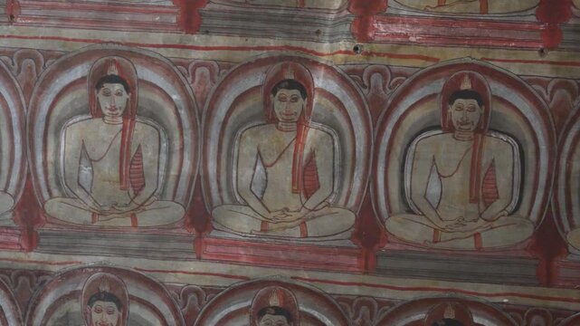 Colorful murals inside Dambulla Cave Temple Sri Lanka, meditating hands repeating texture