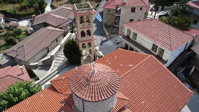 Windy Drone Shot of Old Orthodox Stone Church Flag in Greece