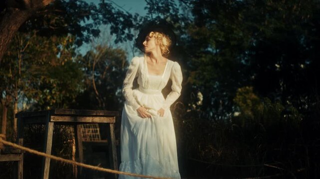 Graceful Female Figure In Flowing Attire Gazing Thoughtfully At Distant Horizon Amidst Golden Evening Ambiance