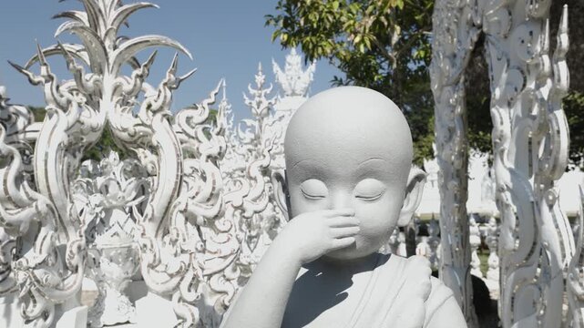 Close-up of white child statue at Wat Rong Khun in Chiang Rai
