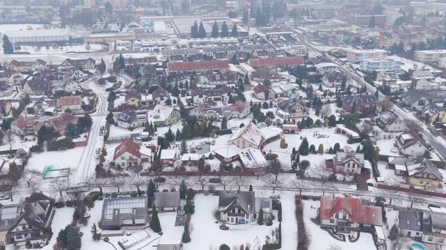 Snowy Svitavy cityscape from drone, winter residential district.
Aerial view of family homes covered in snow.