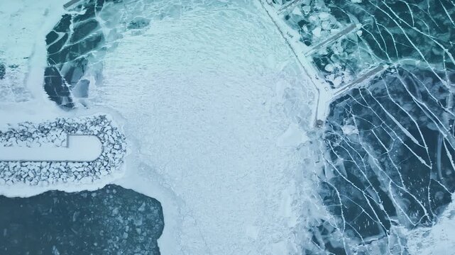 Aerial view of icy Bronte Harbour on Lake Ontario in winter tranquility