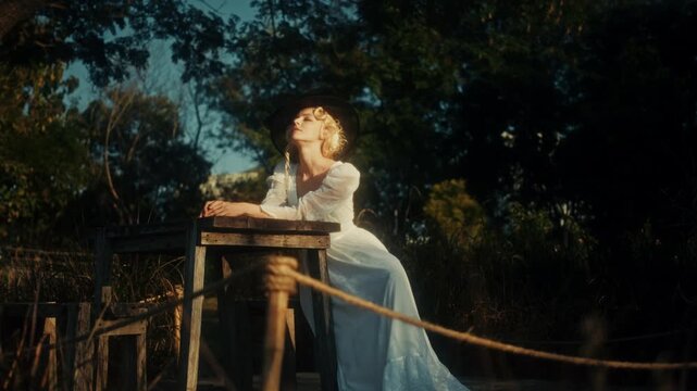 Graceful Female Figure In Flowing Attire Gazing Thoughtfully At Distant Horizon Amidst Golden Evening Ambiance