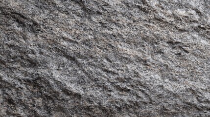 Obraz premium Close-up View of a Rough Granite Surface Highlighting Textured Patterns and Natural Shades of Gray and Black for Background or Design Use