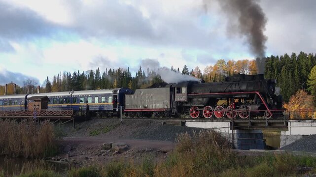 An old steam locomotive with a retro train at the station