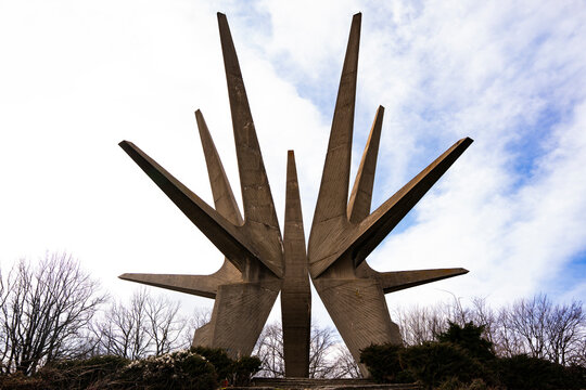 Kosmaj Monument against a dramatic sky. A 40-meter brutalist concrete structure from 1971, commemorating WWII Partisans with five star-shaped fins.Rogaca, Serbia 25.02.2026