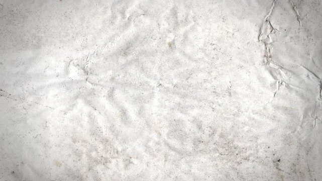 A creased and textured paper tear reveal background with alpha that animates to fill screen in a stop motion style. 
