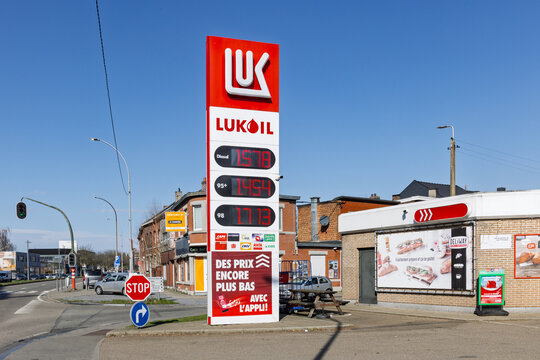Totem sign at a Lukoil gas station in Li&egrave;ge displaying diesel and petrol prices. Adjacent Deliway convenience store and road view. Liege, Belgium, 27 february 2026.