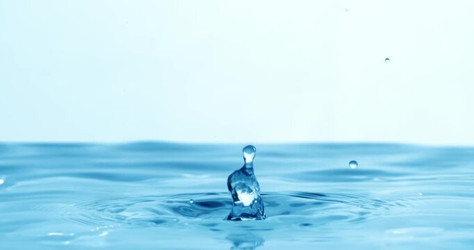 Drop of water falls into a drop of water in a super slow motion. Shot on super slow motion 1600 fps.