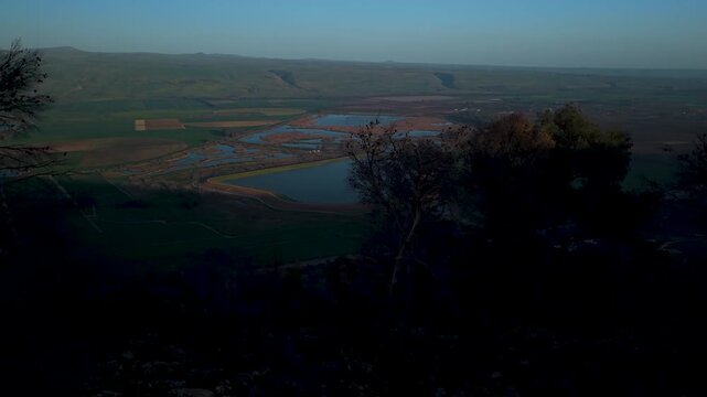 Hula Valley and Golan Heights panorama seen through the natural greenery of Keren Naftali during an aerial flight in Israel.