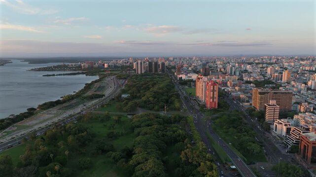 Porto Alegre skyline over Guaiba Lake, Orla do Guaiba and Parque Marinha at sunset. Captured in D-Log with 10-bit color using a Hasselblad sensor.
