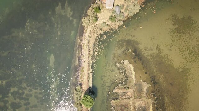 Smooth 4K UHD drone flies forward in a top-down view over the Grado Lagoon, revealing narrow channels, sandbanks and tidal flats&mdash;ideal for nature docs, b-roll.