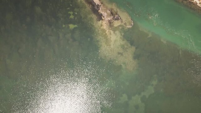 Smooth drone flies forward in a top-down view over the Grado Lagoon, revealing narrow channels, sandbanks and tidal flats&mdash;ideal for nature docs, b-roll.