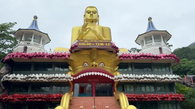 Panorama of the Golden Buddha statue at Dambulla Golden Temple, Sri Lanka. UNESCO World Heritage site, Buddhist museum, and religious landmark.
