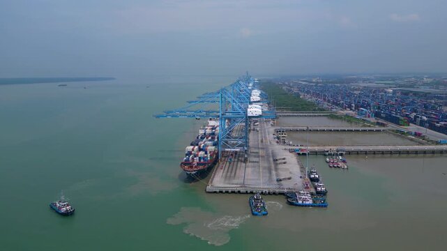 speed ramp hyper motion time lapse Cargo ships loading and unloading at Northport terminal, showing global logistics and international trade activity. Magic aerial view wide orbit panorama overview d