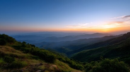 Fototapeta premium Serene panoramic view of layered mountains at sunset with a gradient sky and soft golden light illuminating the landscape