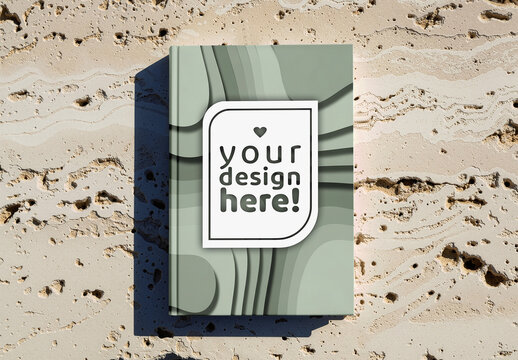 Book Placed On A Slab Of Raw Travertine Stone Mockup
