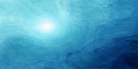 Abstract blue background of a frozen iceberg floating in the deep sea under a bright summer sky with sunlight reflections on the ocean waves © Julia