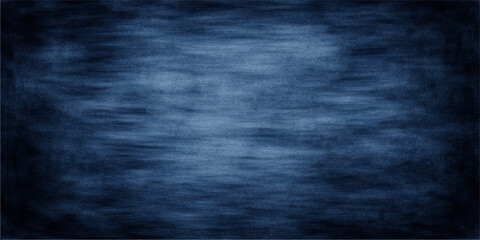 A dark blue grunge background with a textured chalk board surface featuring aged vintage patterns and a rough ancient wall material design © Julia