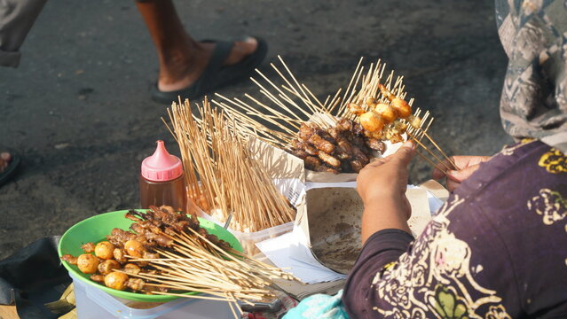Traditional satay skewers sold by a street vendor in Yogyakarta