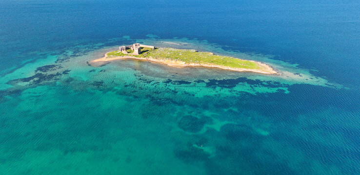 Historic ancient monastery on an island around the Patrica beach. Shooting with drone. (Turkish name; kizlar manastiri) Cunda - Ayvalik - Turkey