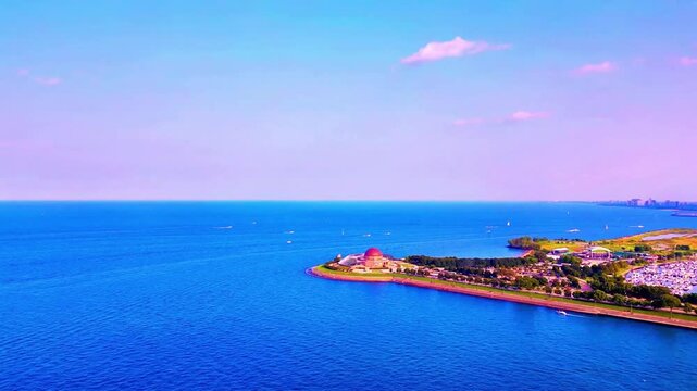 A smooth drone flight over Lake Michigan revealing the iconic Adler Planetarium along the shoreline, with the Chicago skyline rising dramatically in the background for a stunning cinematic view.