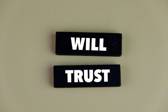 Wooden block with the words will and trust. living trust might be more than you need for your situation, but it can be a great tool if you have a larger or more complex estate