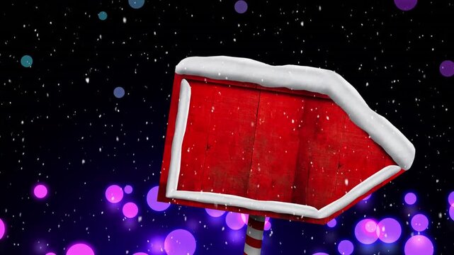 Animation of snow falling at christmas over wooden sign