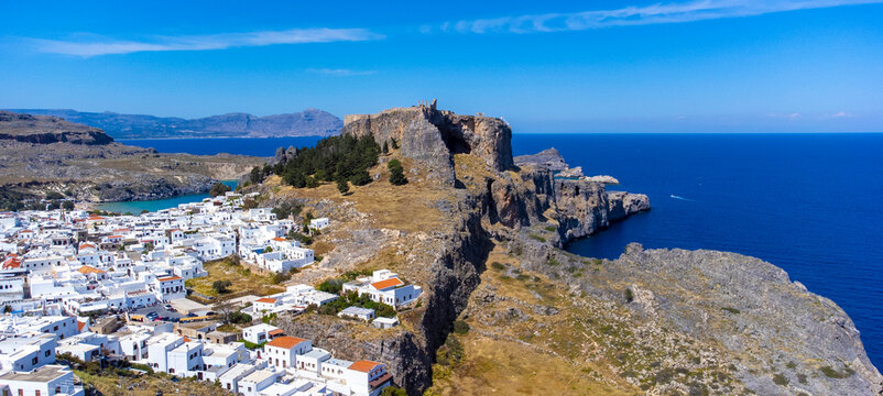 The Acropolis of Lindos in Rhodes island Greece. Saint Paul's Beach and Lindos Acropolis aerial panoramic view.
