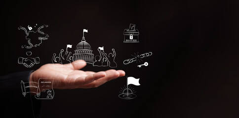 Decolonization concept. Hand holds icons of democracy, independence, and broken chains. National liberation, nation freedom, democracy, declaration, sovereignty, the transition to self-governance.