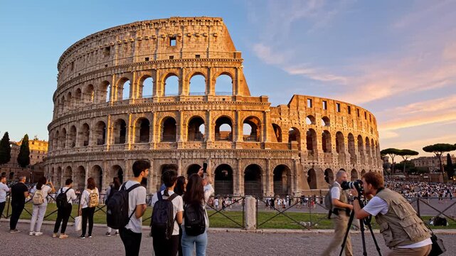 Tourists at ancient colosseum during sunset