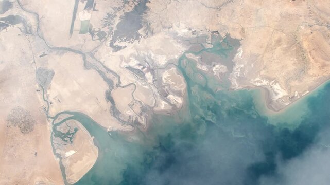 Flying over Basra Iraq river delta view from space satellite view with clouds based on Nasa imagery