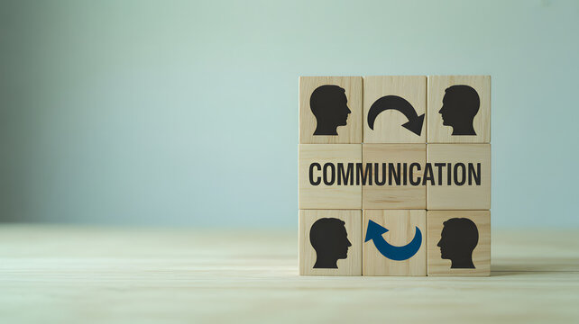 A grid of wooden blocks with communication text and a blue arrow icon on a light wooden surface