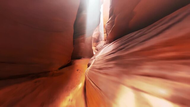 Fast fpv drone navigating tight red sandstone slot canyon dodging curved rock wall in dry desert showing geological formation erosion harsh environment nature travel and dynamic flight