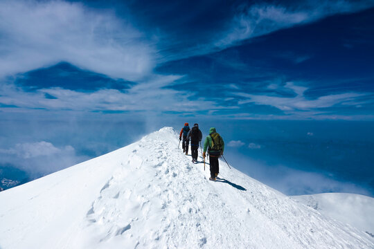 Three Climbers Crossing the Mont Blanc Summit Ridge in Perfect Weather