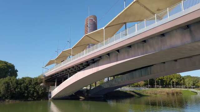 Cachorro Bridge over Guadalquivir in Seville, Spain, as seen from the river, with the Sevilla Tower in the background