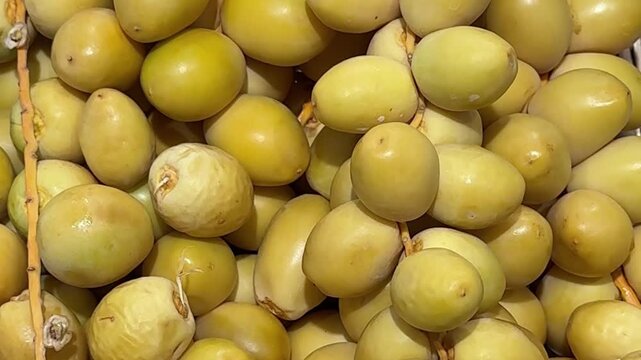 raw dates on a branch palm fruit tasty snack fresh gourmet food background on the table rustic food top view copy space dark background keto and paleo diet vegetarian and vegan food 
