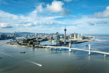 Fototapeta premium High angle view of modern city skyscrapers and the Macau Tower by the sea in Macau, China.