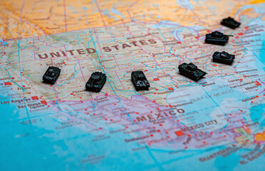 Obraz premium Miniature military tanks on map representing USA national defense.