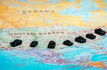 Obraz premium Miniature military tanks on map representing USA national defense.