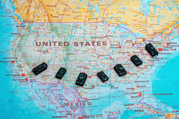 Obraz premium Miniature military tanks on map representing USA national defense.
