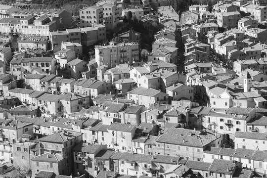Aerial view of Tolfa old town with terracotta rooftops in black and white