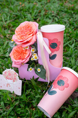 Pink Flower and Drink Set with Paper Cups on Grass