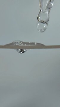 Liquid serum beauty product that comes out of the serum pipette, forming liquid bubbles
