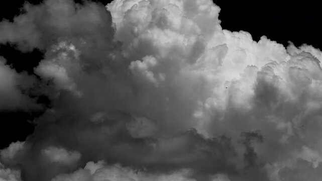 Time-lapse of separate white clouds on a black background has real clouds. White cloud isolated on a black background, realistic cloud