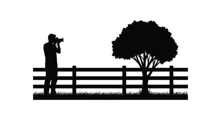 A photographer stands with camera observing nature by a fence and tree presented as a silhouette high quality professional detailed modern © CreativeAkash099