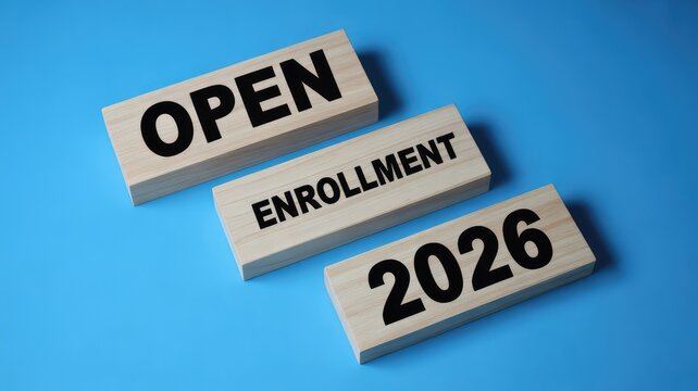 Open Enrollment 2026 clearly displayed on three wooden blocks on a vibrant blue background indicating a new pe