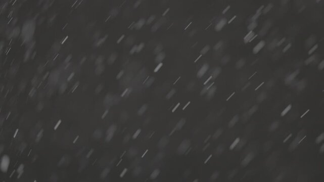 Slow motion falling snow particles on dark background, cinematic winter atmosphere with dense blizzard effect, swirling flakes, bokeh for overlays. ProRes 422, 10 bit ungraded C-LOG2, Slow motion vide