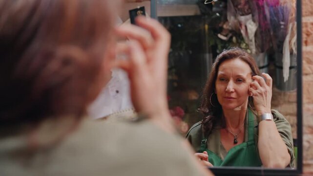 Setting up boutique for attentive customers. Ensuring perfect presentation before welcoming shoppers inside. Final preparations being made to offer welcoming and excellent shopping experience