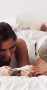 Hug, pregnancy test and surprise with couple in bed together for celebration, good news or moment. Funny, pregnant and wow with excited people embracing in bedroom of home for ivf success or love